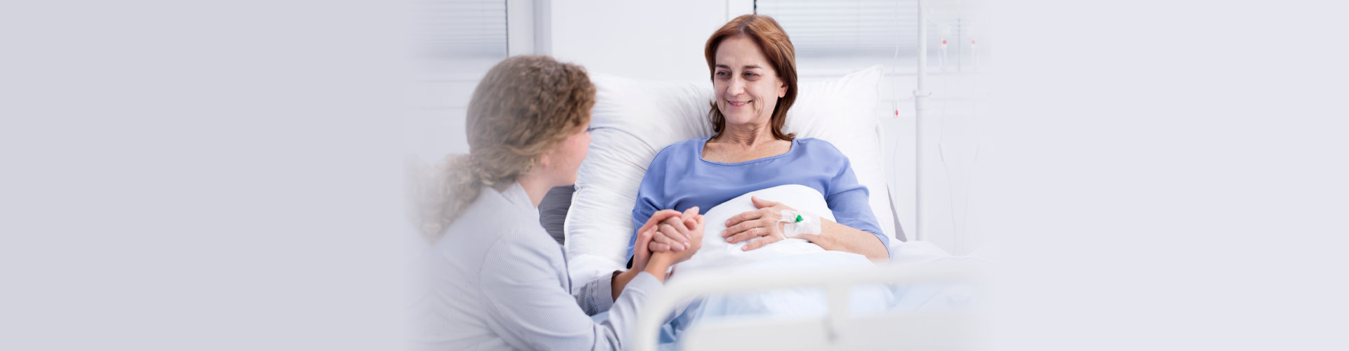 caregiver checking up a bedridden woman