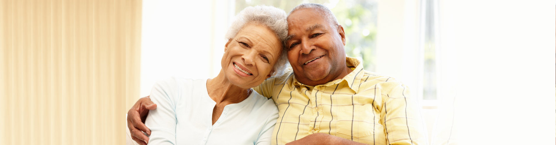 elderly couple smiling at the camera